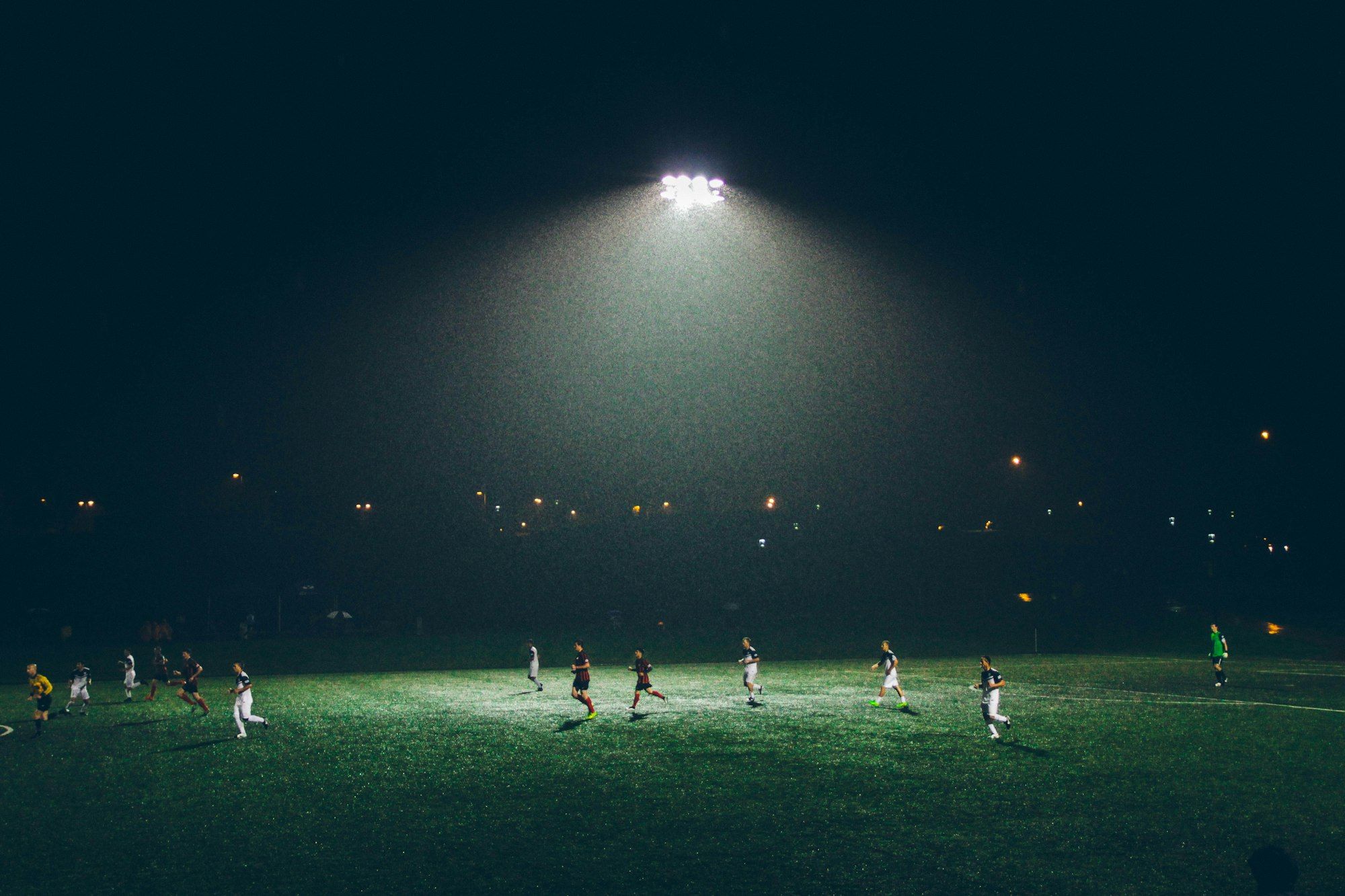 Youth players training under floodlights